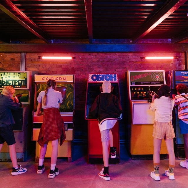 People playing arcade machines