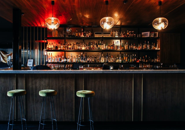 A row of chairs in front of a bar