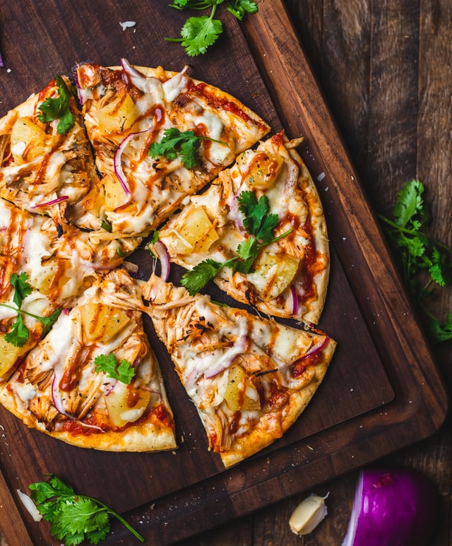 Cooked pizza on a serving board